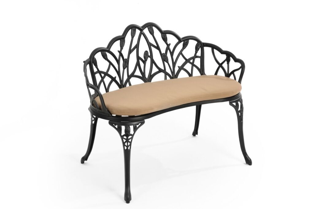 Black cast aluminum garden bench with floral backrest and beige cushion