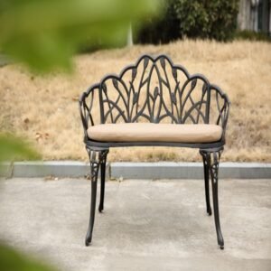 Black cast aluminum garden bench with cushion shown outdoors