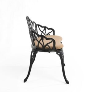 Side view of black cast aluminum garden bench with cushion