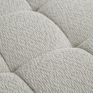 Close-up of soft beige velvet upholstery and tufted cushioning